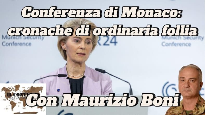 Conferenza di Monaco: cronache di ordinaria follia Una donna parla sul podio della Conferenza di Monaco; la cronache menzionano Maurizio Boni e l'evento.